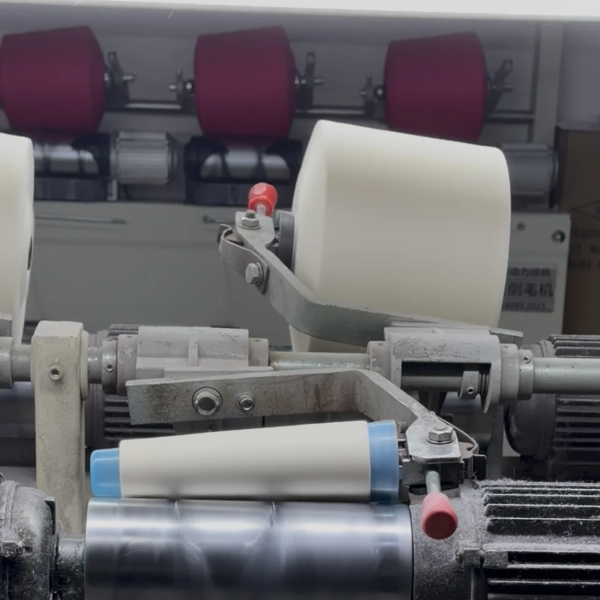 Production area with skilled workers monitoring computerized knitting machines in a Shantou knitwear factory