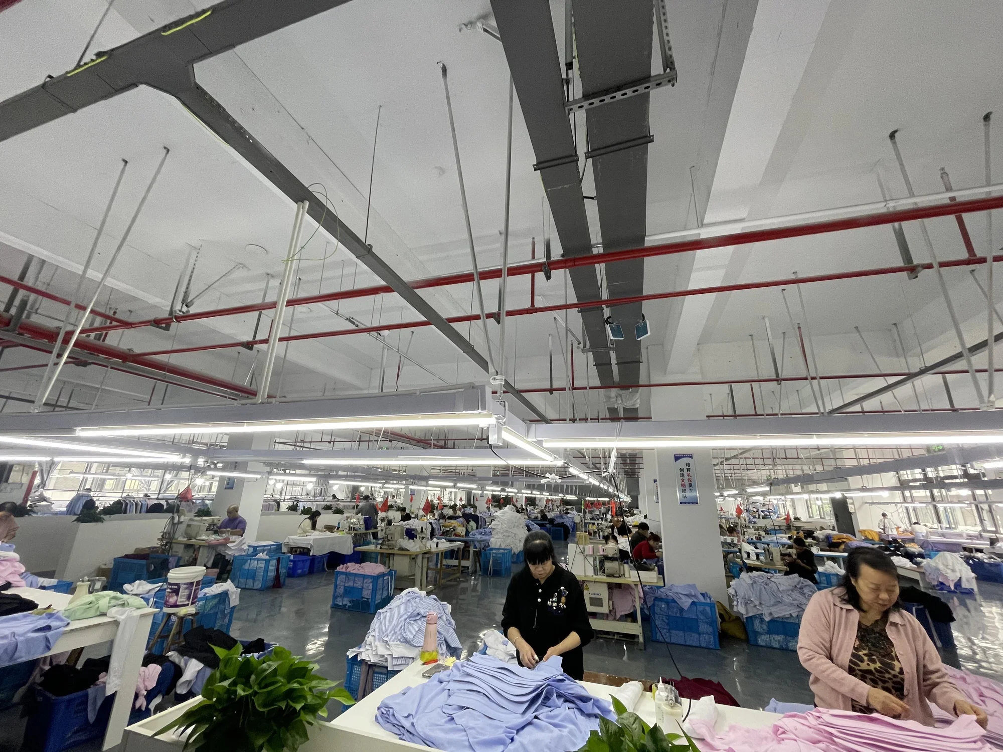 Steaming and pressing station in the finishing department where knitwear garments receive their final shape and hand feel